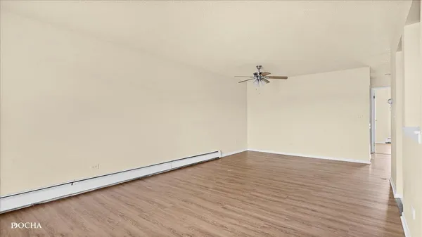 a view of a room with wooden floor