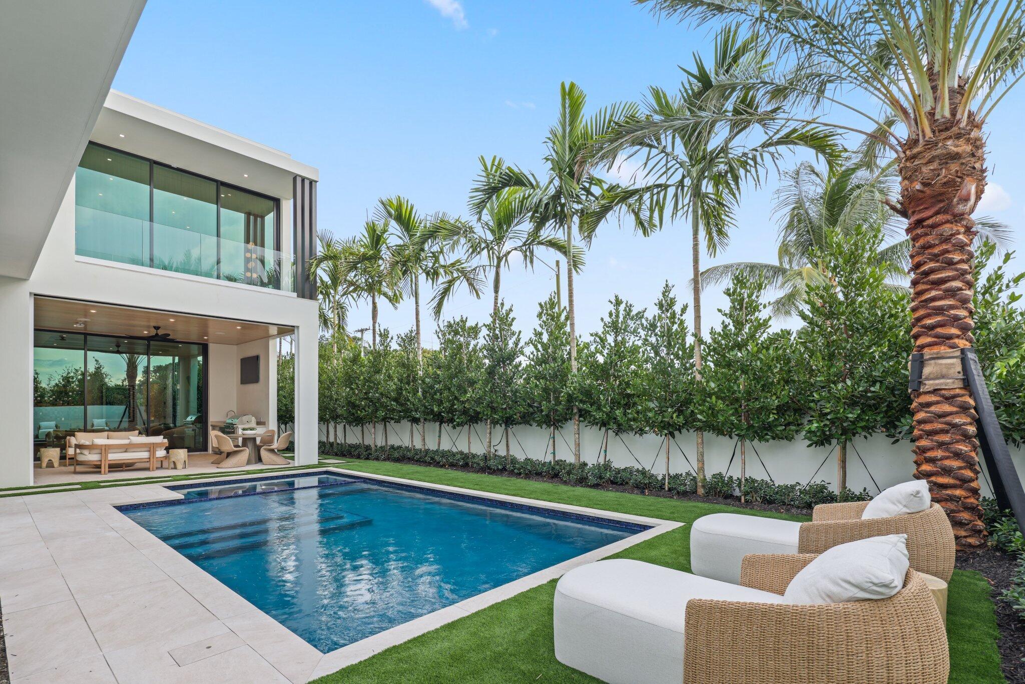 340 Grove Place Delray Beach, FL 33444 - Photo 36 of 89 a view of a swimming pool with couches and a table and chairs