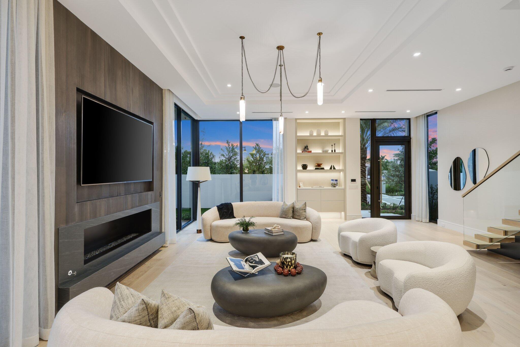 340 Grove Place Delray Beach, FL 33444 - Photo 10 of 89 a living room with furniture a flat screen tv and a large window