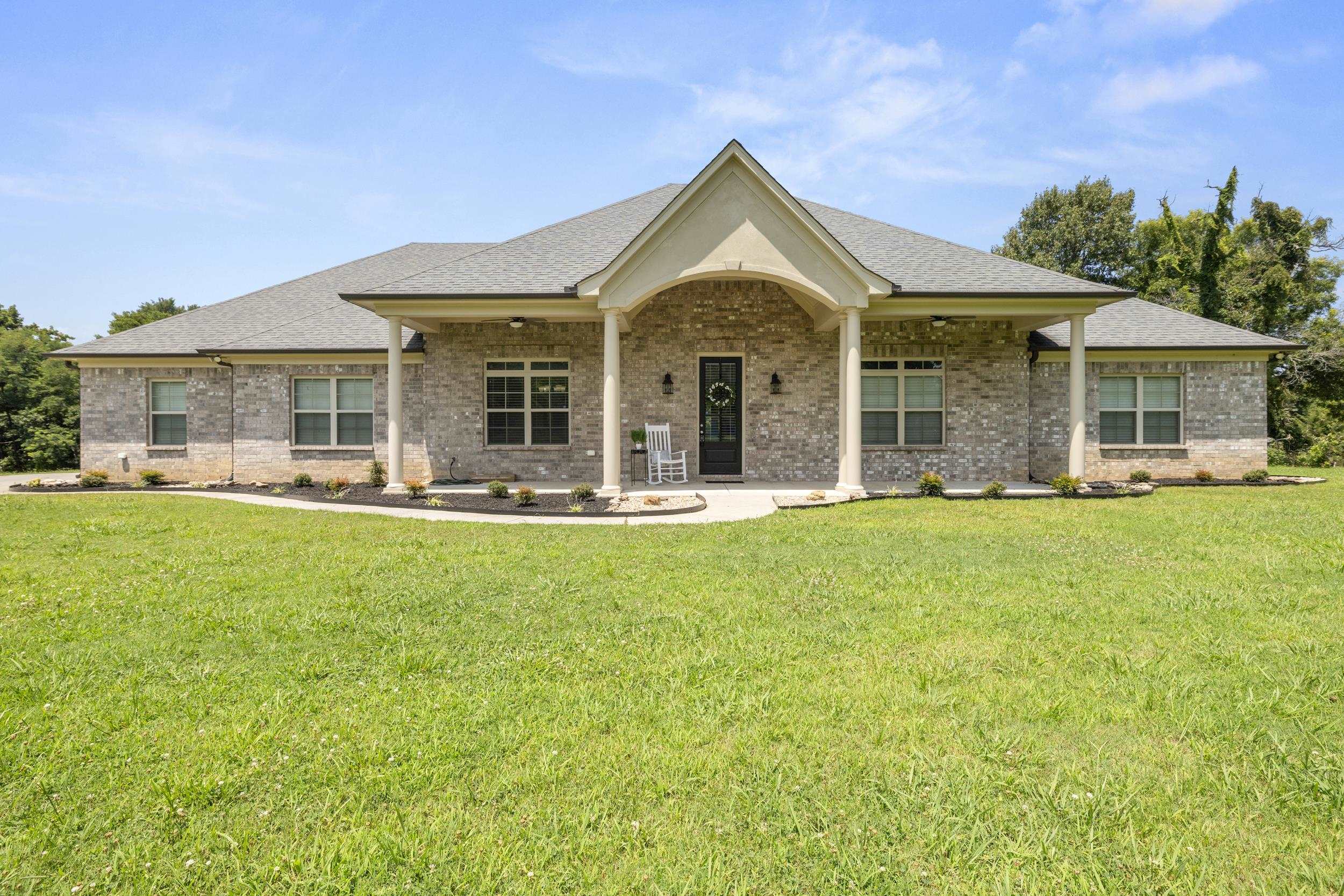 185 Belmont Road Mason, TN 38049 - Photo 2 of 38 Brick facade with a covered entry featuring columns