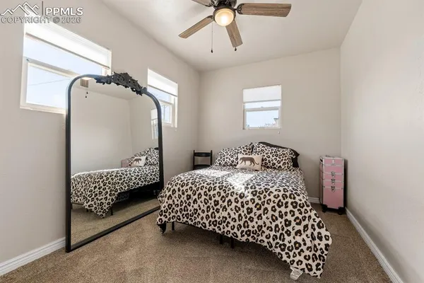 a bedroom with a bed dresser and a window