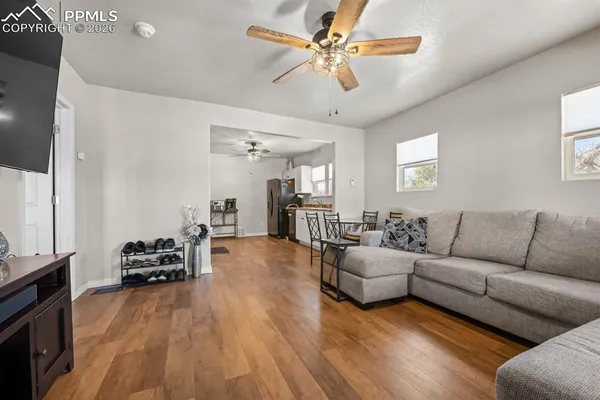 a living room with furniture and a wooden floor