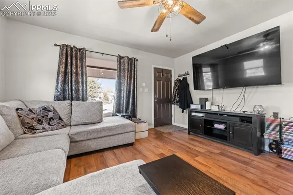 a living room with furniture and a flat screen tv