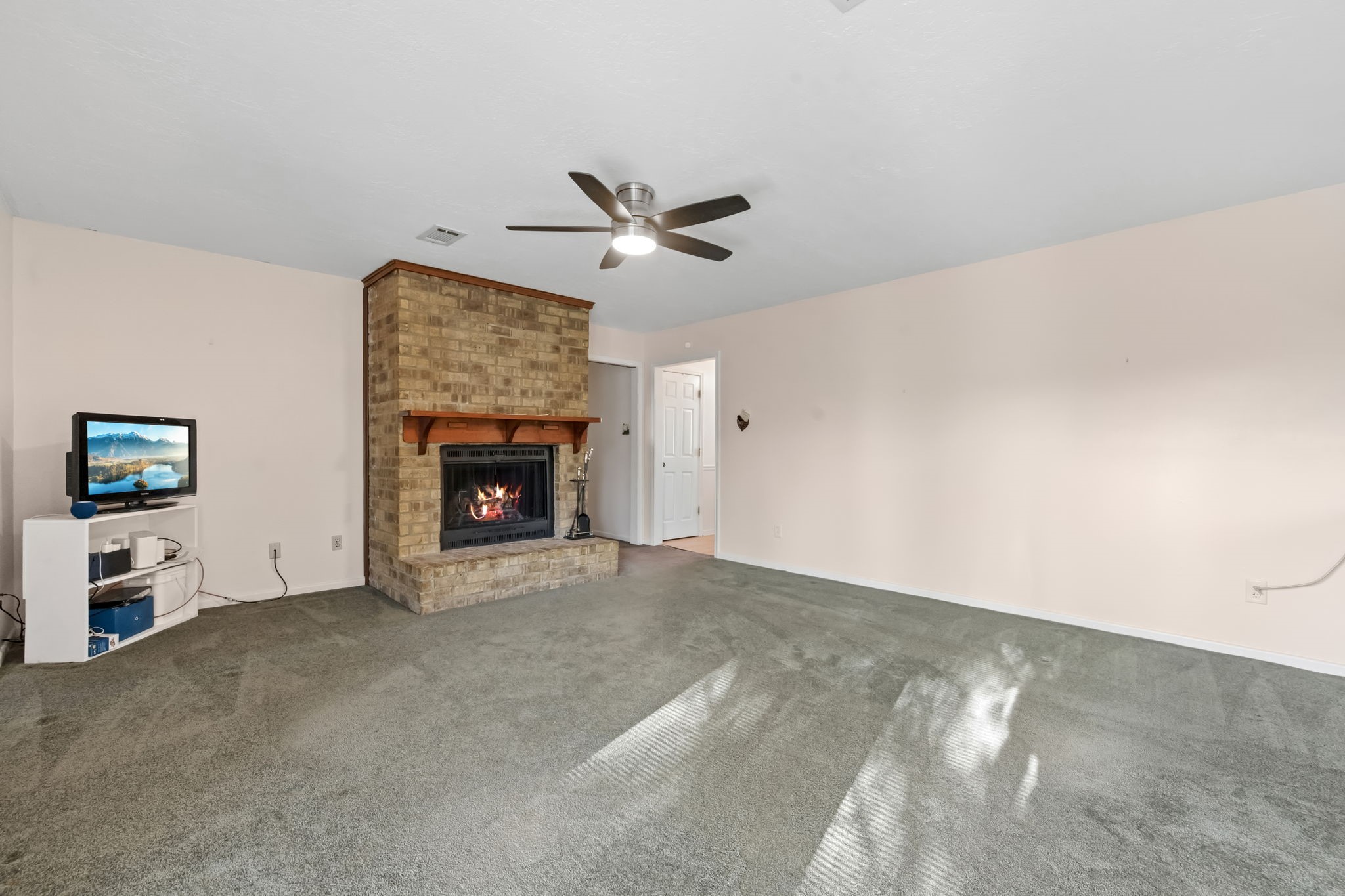 1609 Bowie Street Liberty, TX 77575 - Photo 11 of 24 a view of an empty room with window and fireplace