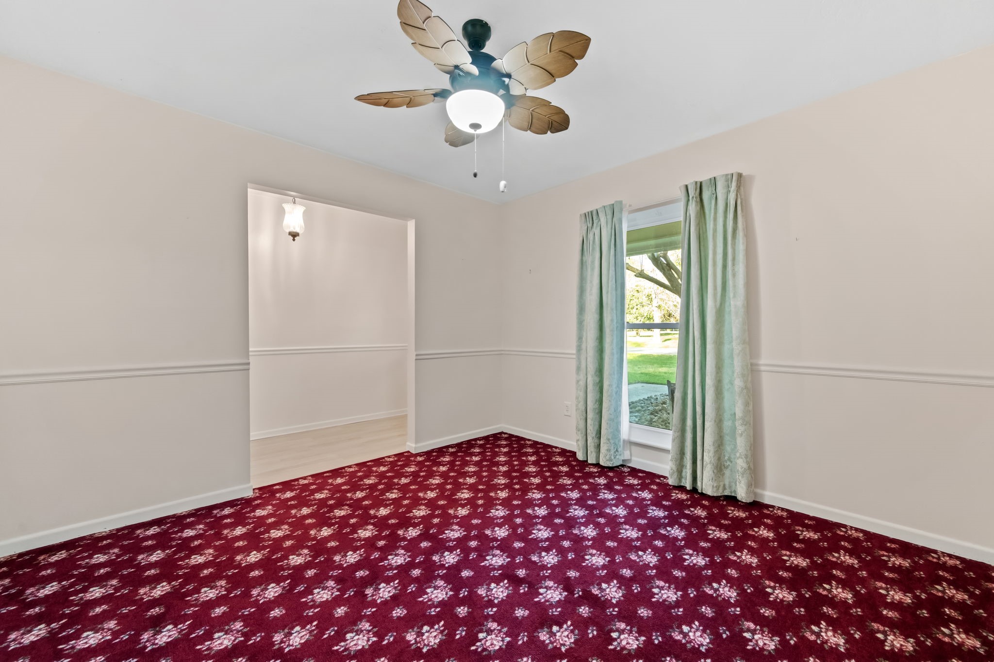 1609 Bowie Street Liberty, TX 77575 - Photo 13 of 24 a bedroom with a bed and a chandelier