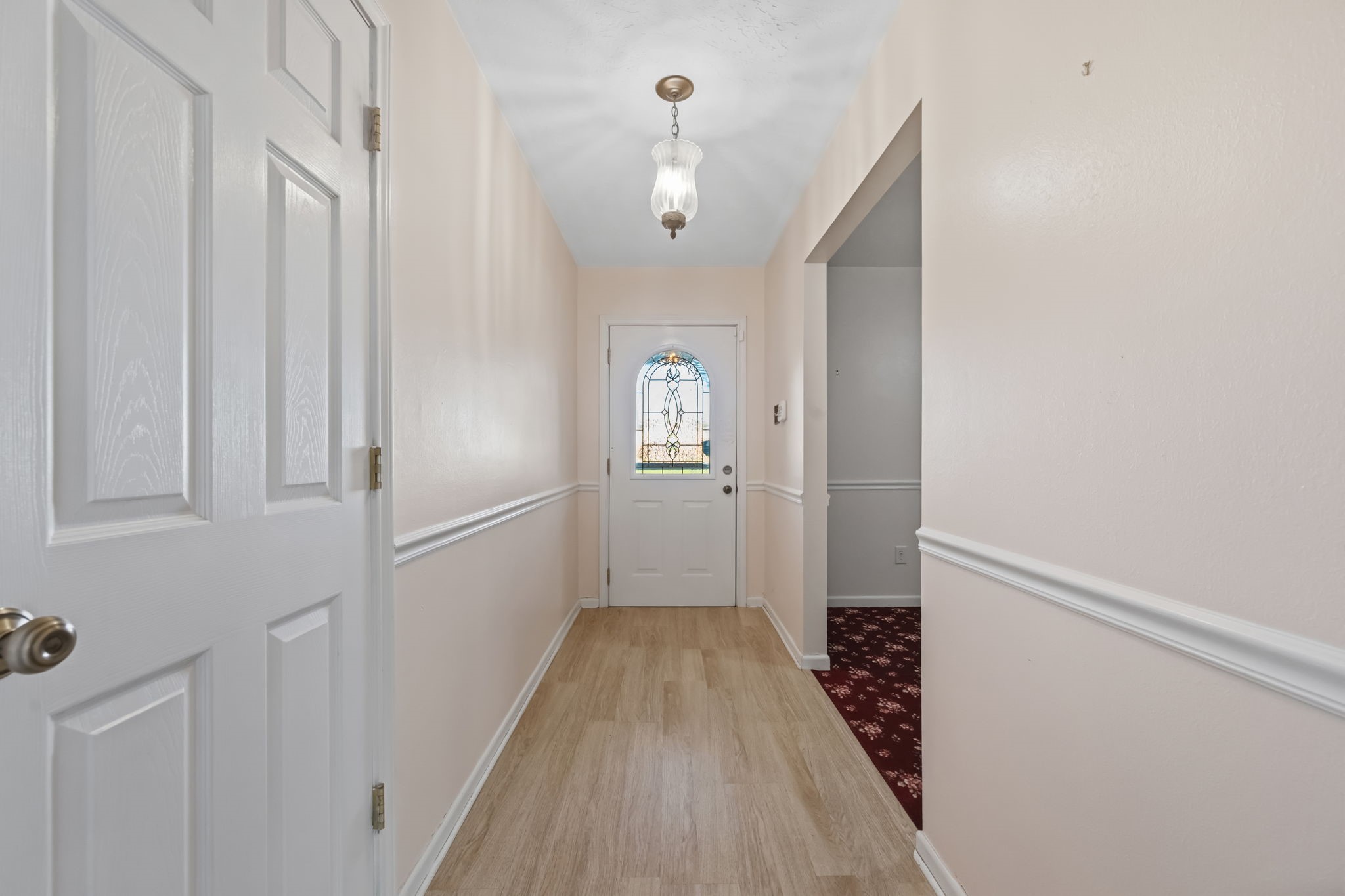 1609 Bowie Street Liberty, TX 77575 - Photo 14 of 24 a view of a hallway with wooden floor and staircase