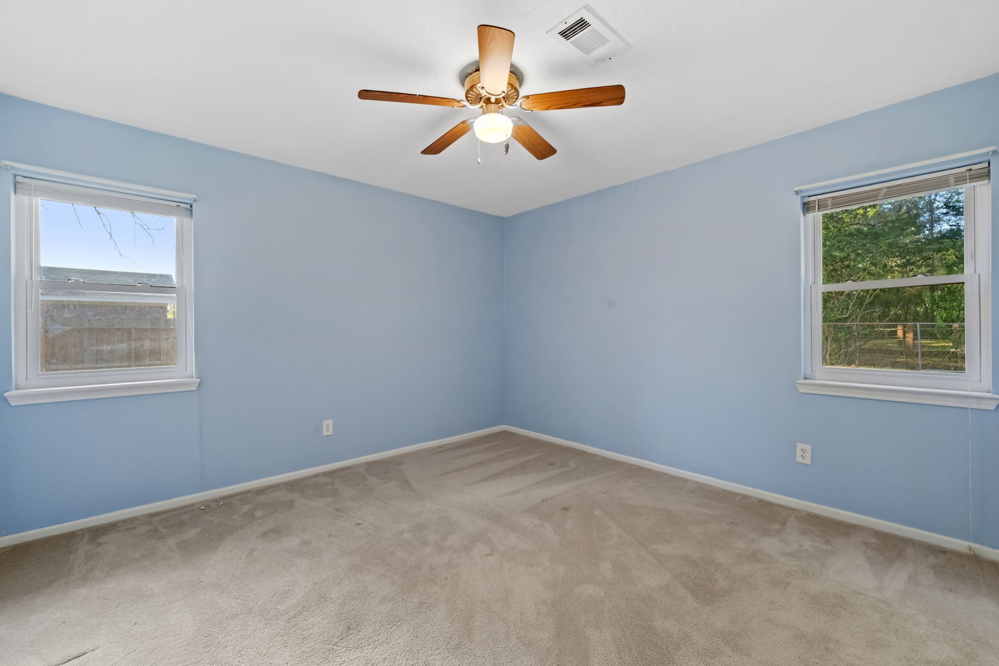 1609 Bowie Street Liberty, TX 77575 - Photo 15 of 24 an empty room with a window and a fan