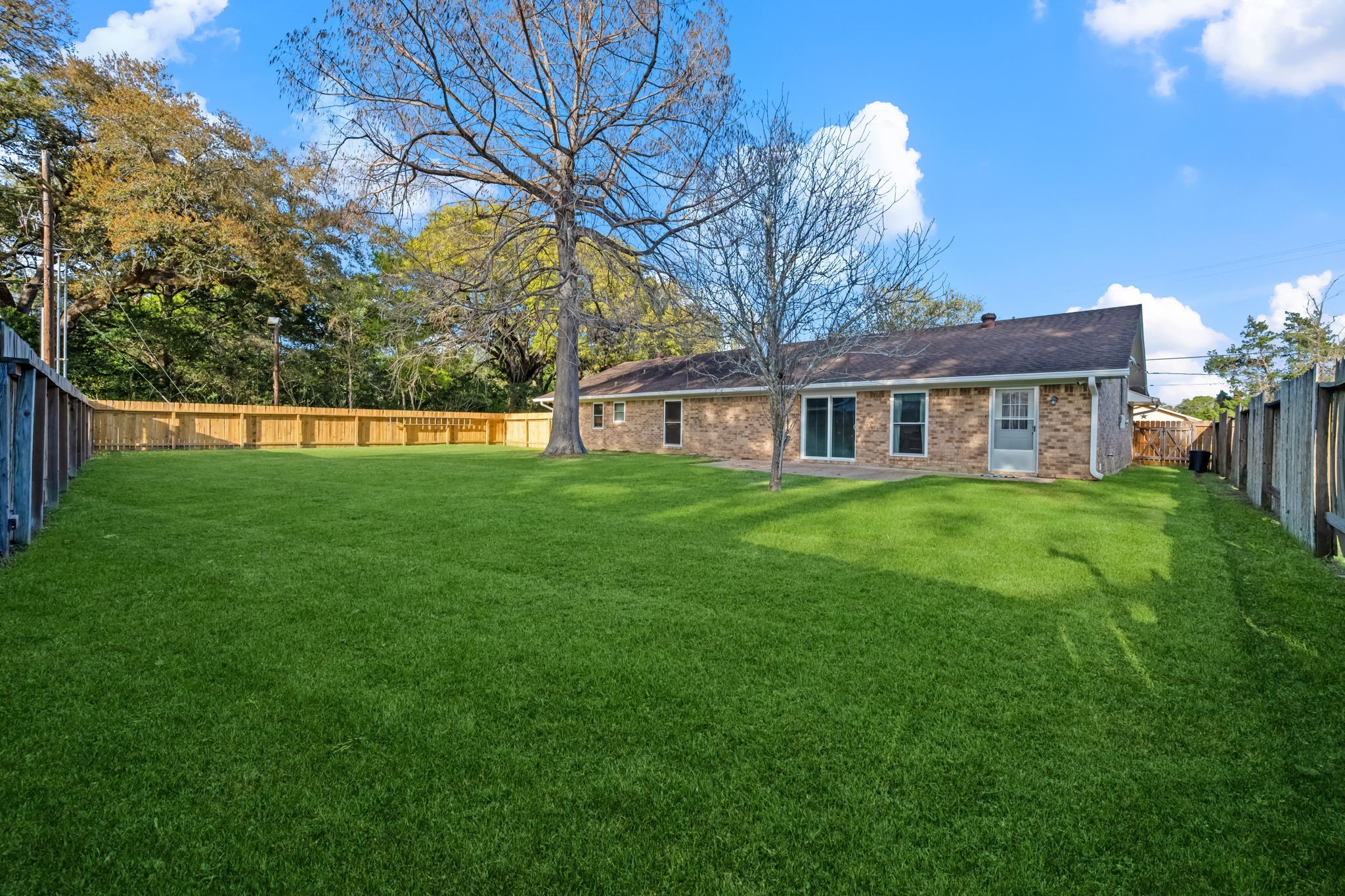 1609 Bowie Street Liberty, TX 77575 - Photo 4 of 24 a house view with swimming pool and garden
