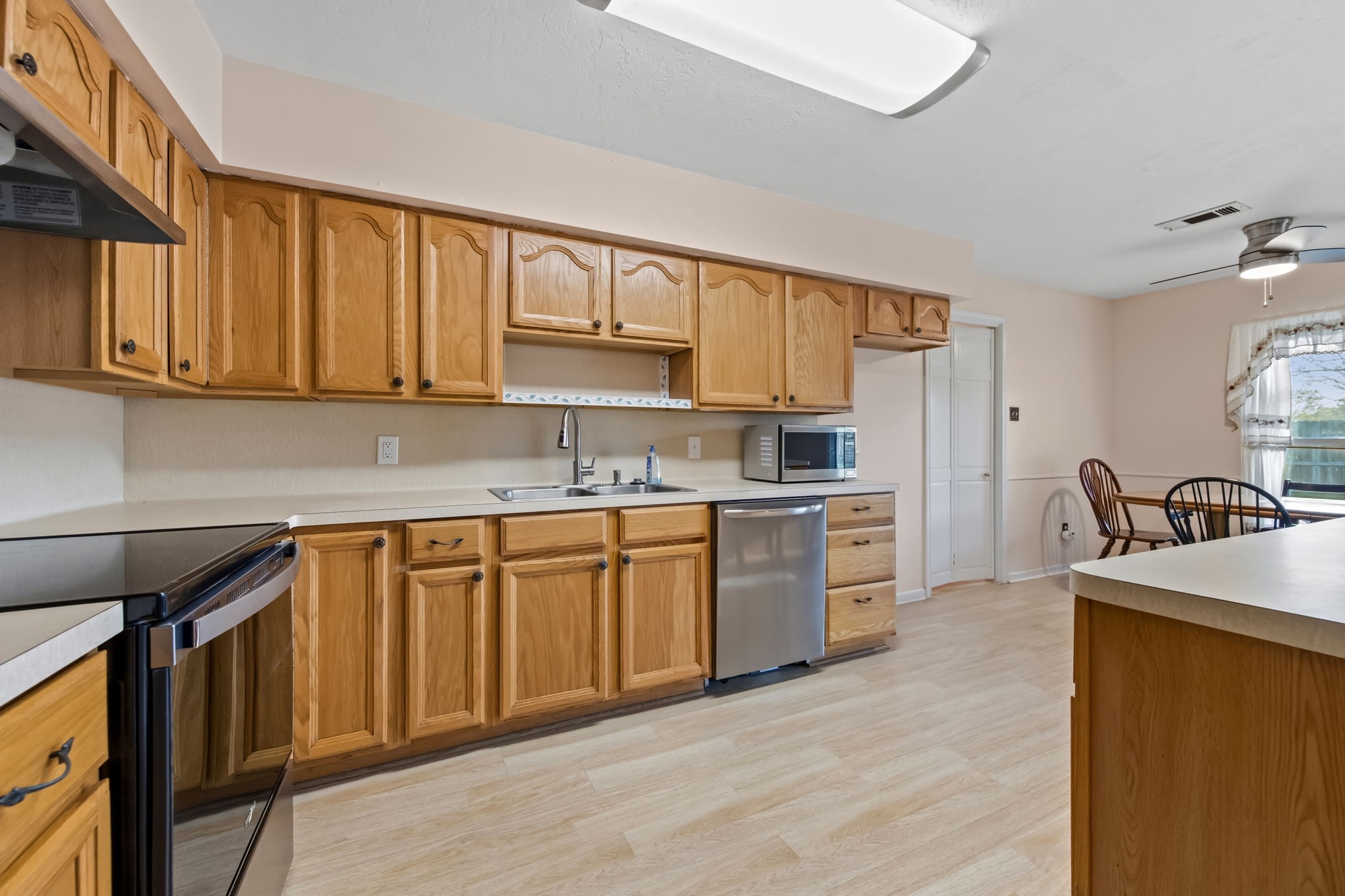 1609 Bowie Street Liberty, TX 77575 - Photo 5 of 24 a kitchen with stainless steel appliances granite countertop a sink dishwasher stove and refrigerator