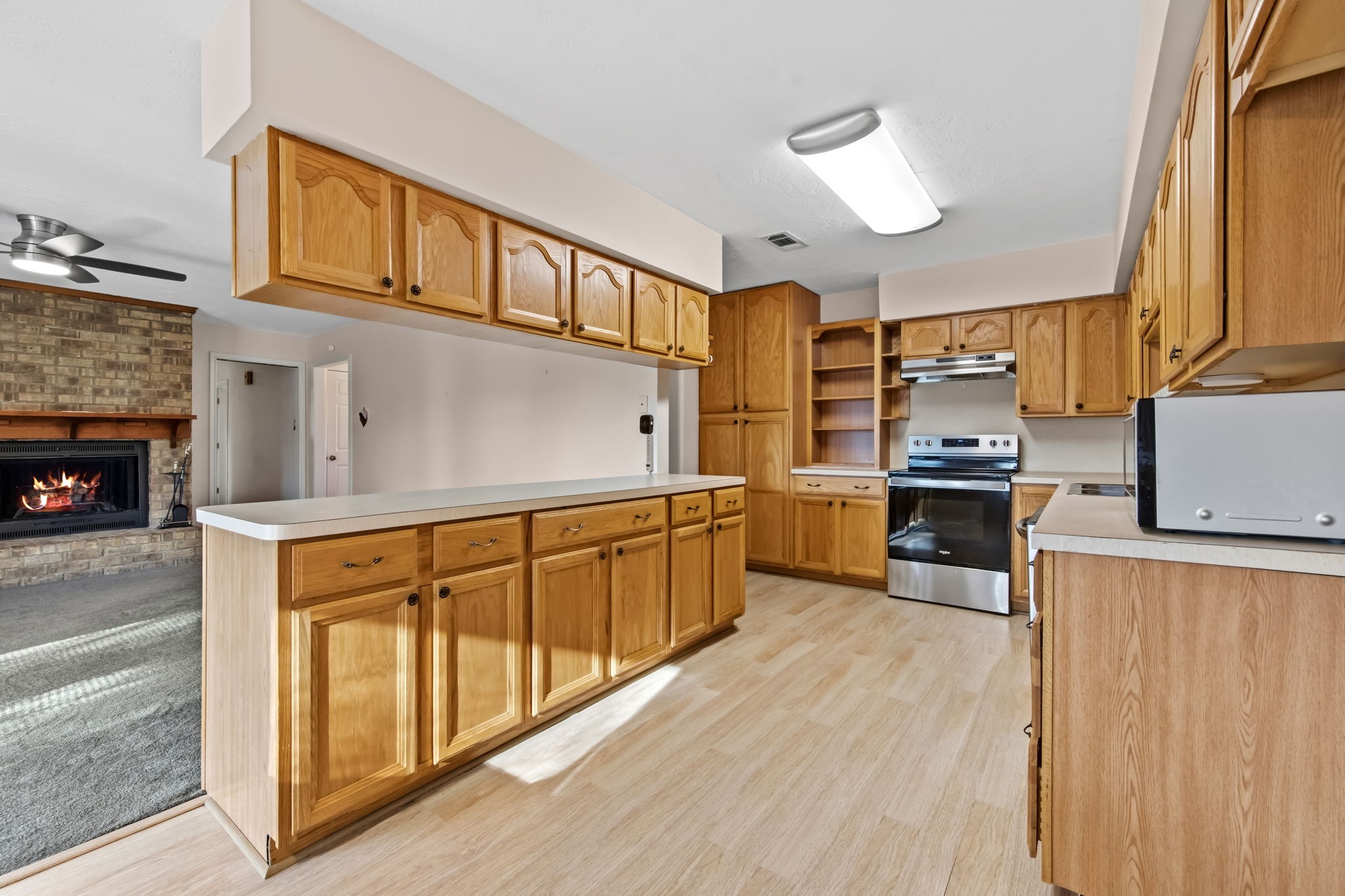 1609 Bowie Street Liberty, TX 77575 - Photo 7 of 24 a kitchen with stainless steel appliances granite countertop a stove a sink and a refrigerator