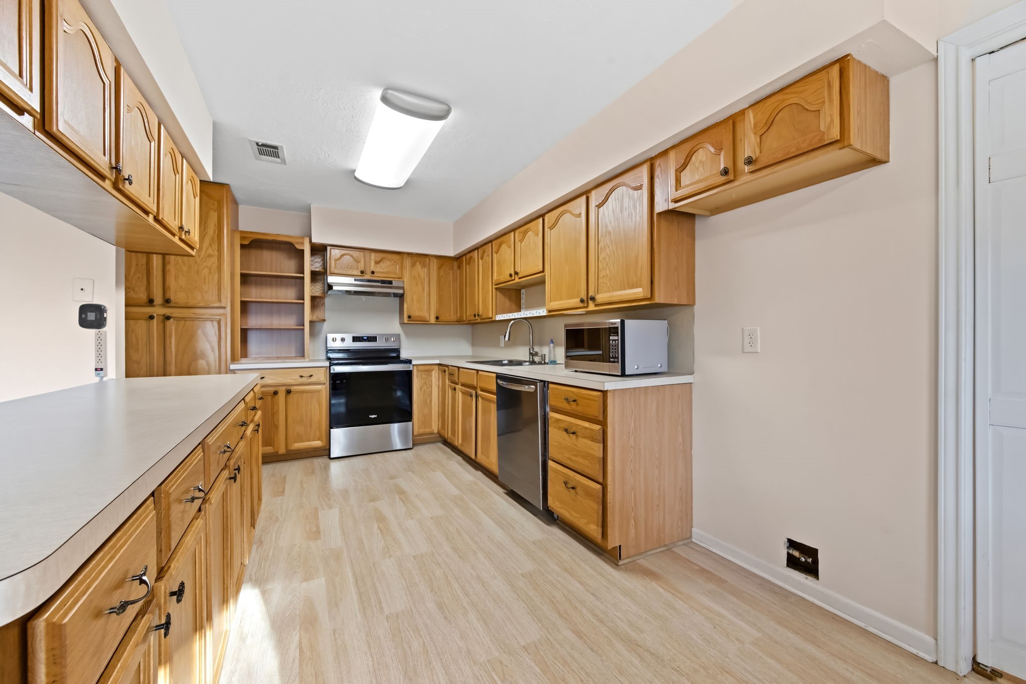 1609 Bowie Street Liberty, TX 77575 - Photo 8 of 24 a kitchen with stainless steel appliances granite countertop a refrigerator a stove top oven a sink and dishwasher
