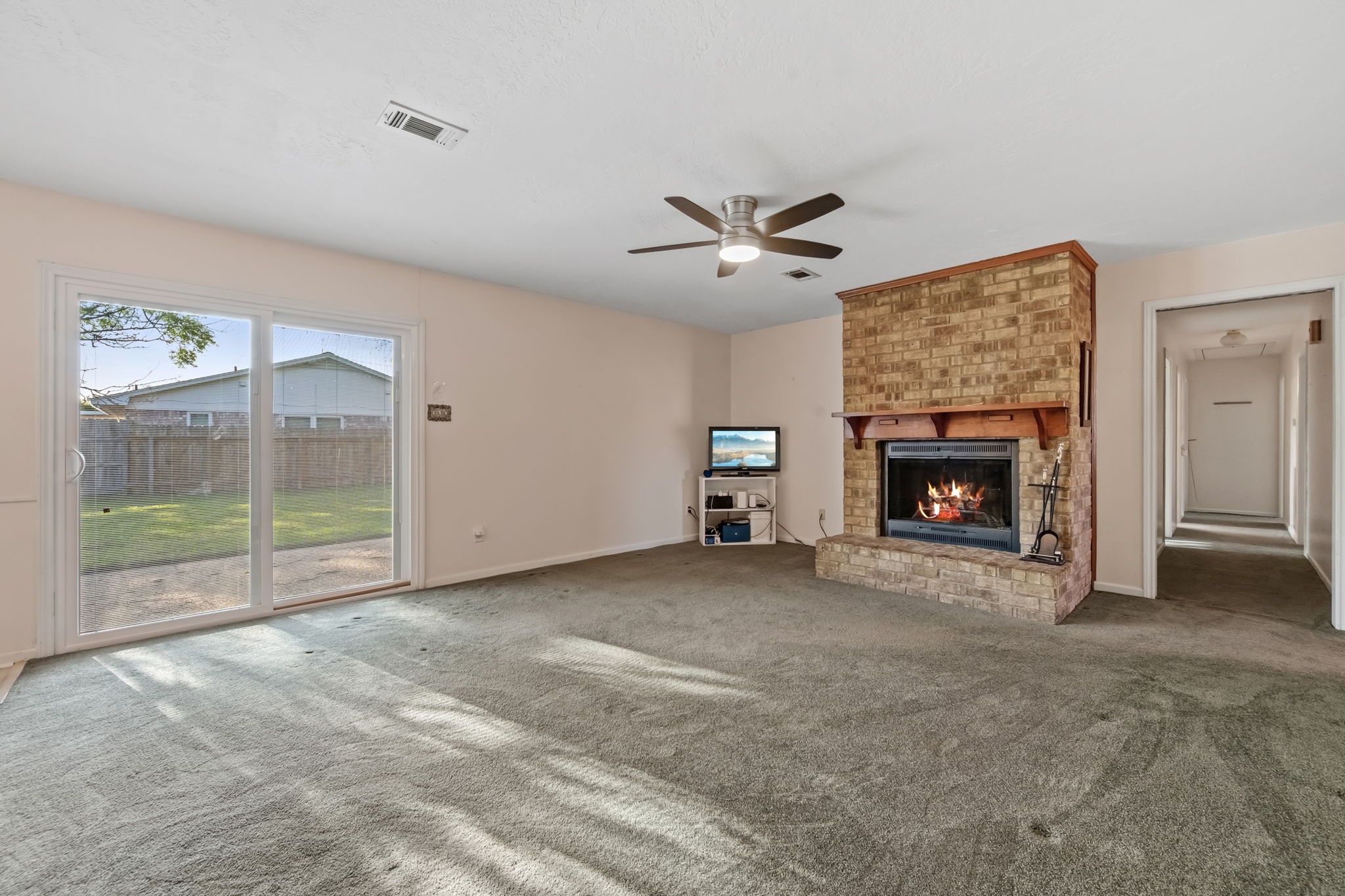 1609 Bowie Street Liberty, TX 77575 - Photo 10 of 24 a view of an empty room with a fireplace and a window