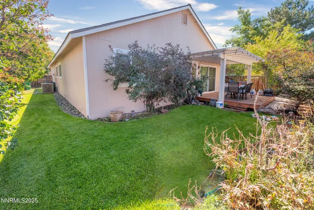 a view of a house with backyard and sitting area