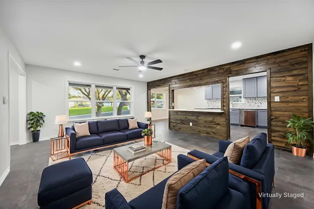 a living room with fireplace furniture and a flat screen tv