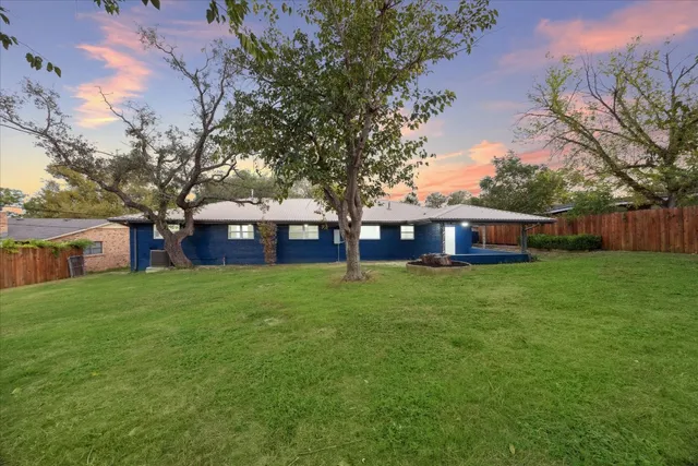 a view of a backyard with a sitting area