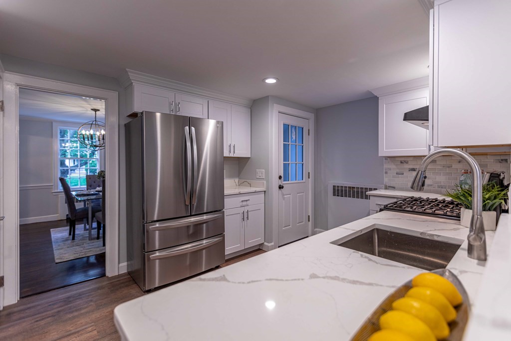 49 Pilgrim Road Wellesley, MA 02481 - Photo 11 of 25 a kitchen with stainless steel appliances granite countertop a refrigerator sink and stove