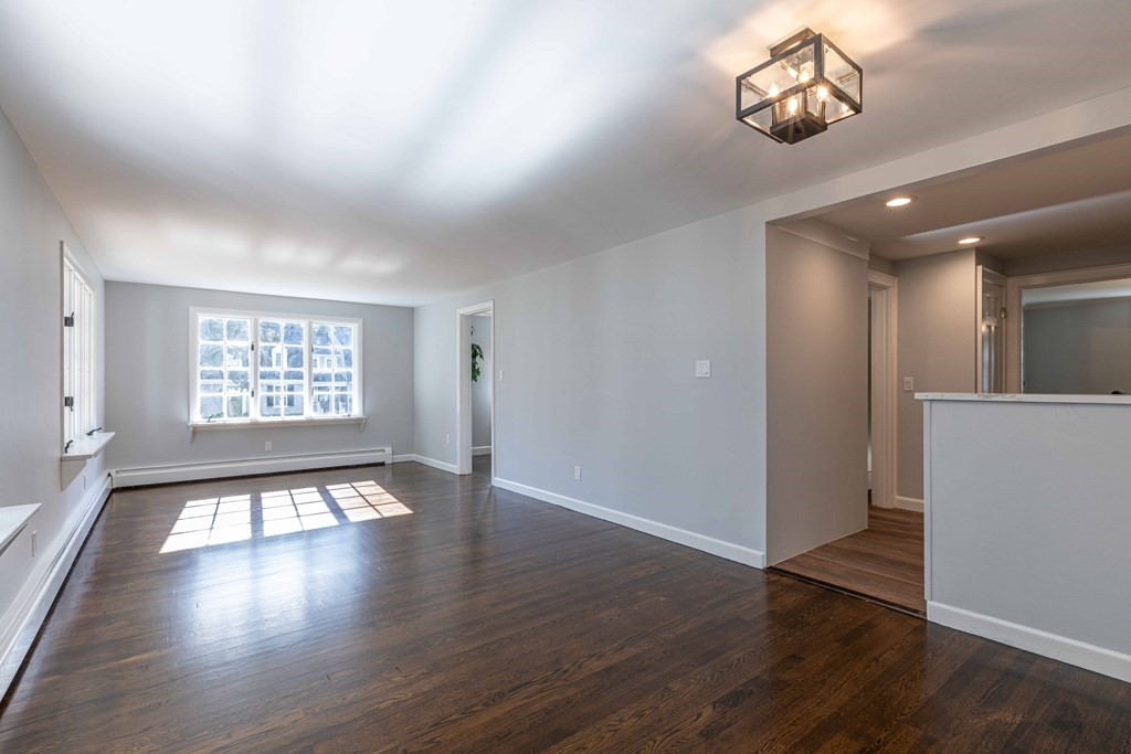 49 Pilgrim Road Wellesley, MA 02481 - Photo 12 of 25 an empty room with wooden floor and windows