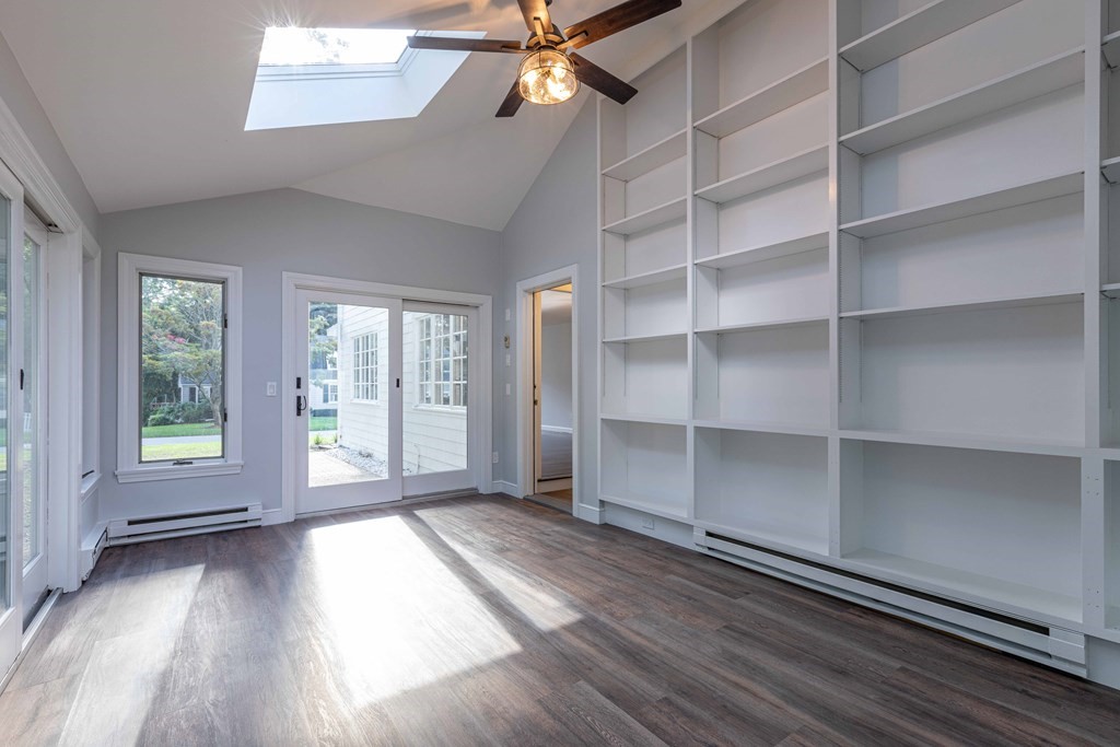 49 Pilgrim Road Wellesley, MA 02481 - Photo 14 of 25 a view of an empty room with a window and wooden floor