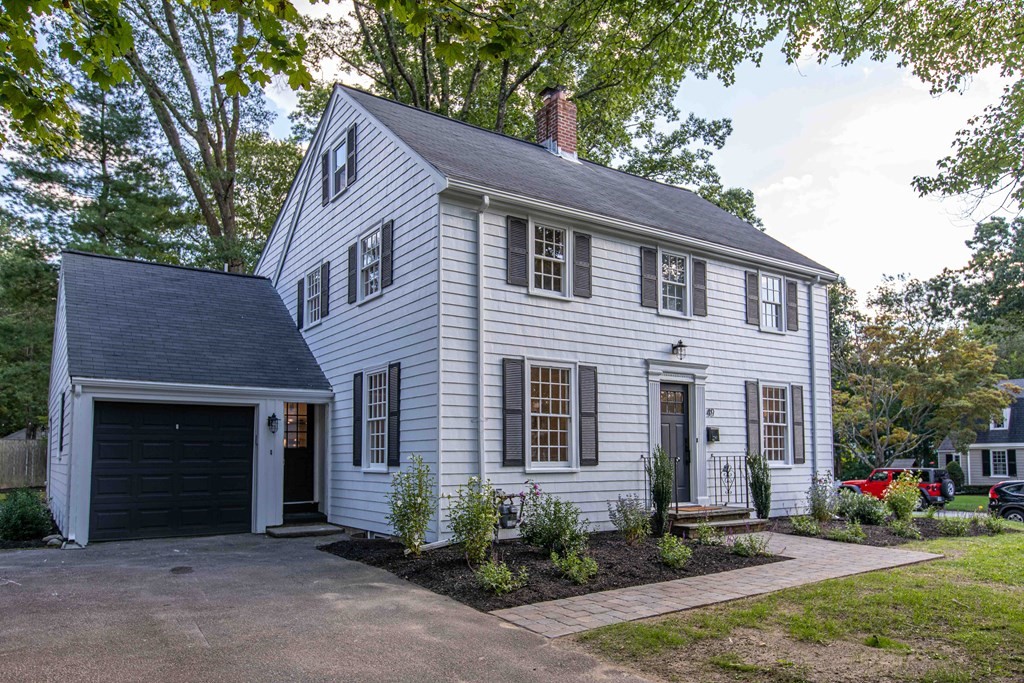 49 Pilgrim Road Wellesley, MA 02481 - Photo 3 of 25 a front view of a house with a yard and garage
