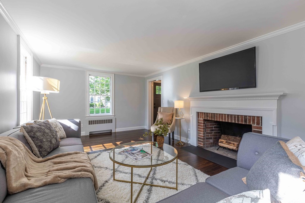 49 Pilgrim Road Wellesley, MA 02481 - Photo 6 of 25 a living room with furniture a fireplace and a flat screen tv