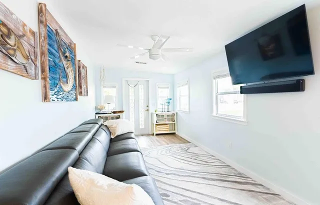 a living room with furniture and a flat screen tv