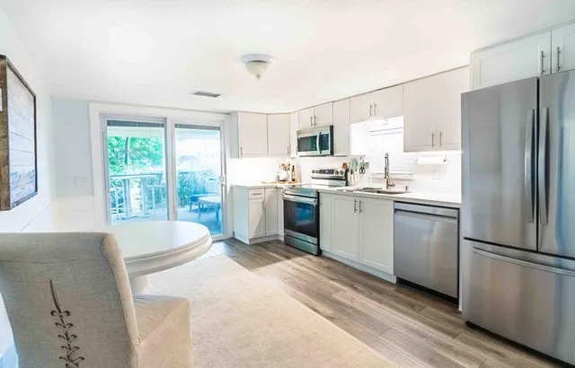 a kitchen with a sink a refrigerator and window