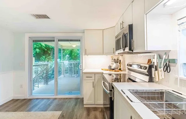 a kitchen with a stove a sink and a refrigerator