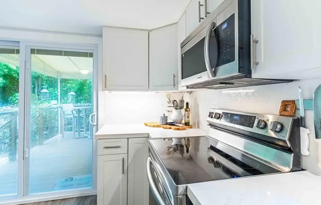 a kitchen with stainless steel appliances a stove a sink and a microwave