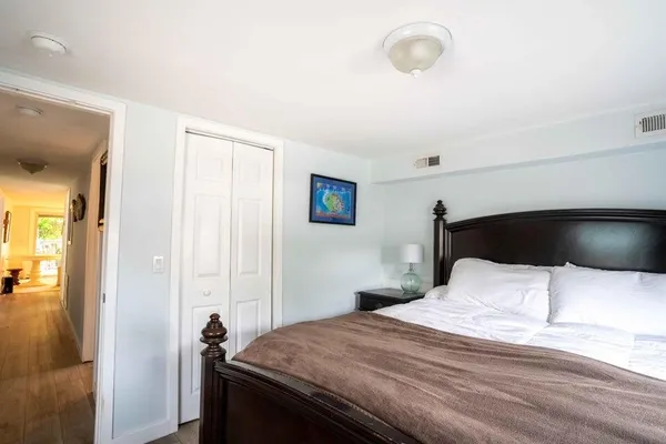 a spacious bedroom with a bed and a couch