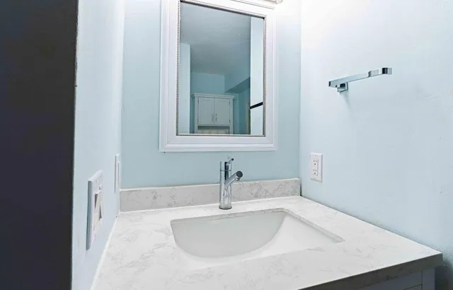a bathroom with a sink and mirror