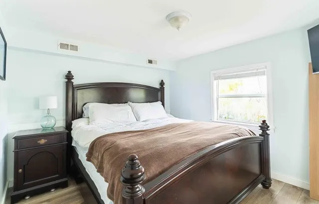 a bedroom with a bed and a window