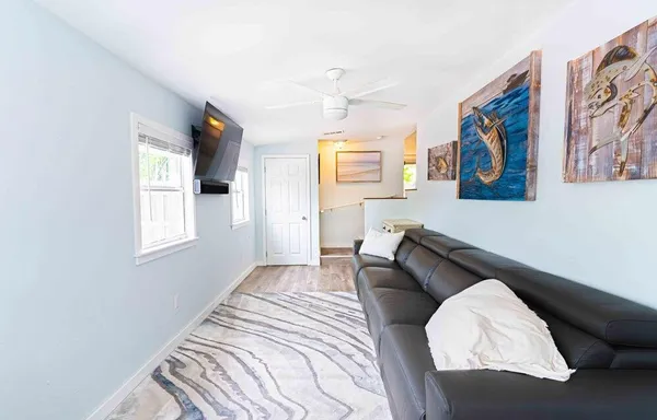 a bedroom with a bed and a painting on the wall