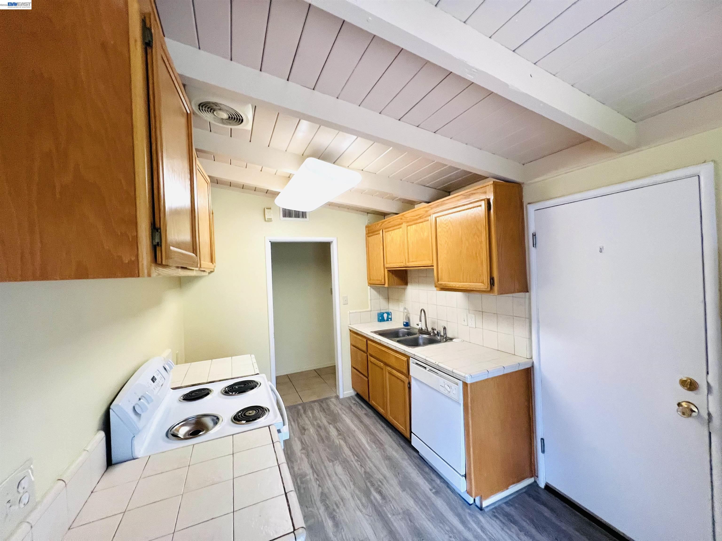 739 M Street Davis, CA 95616 - Photo 6 of 14 a kitchen with a sink and wooden cabinets