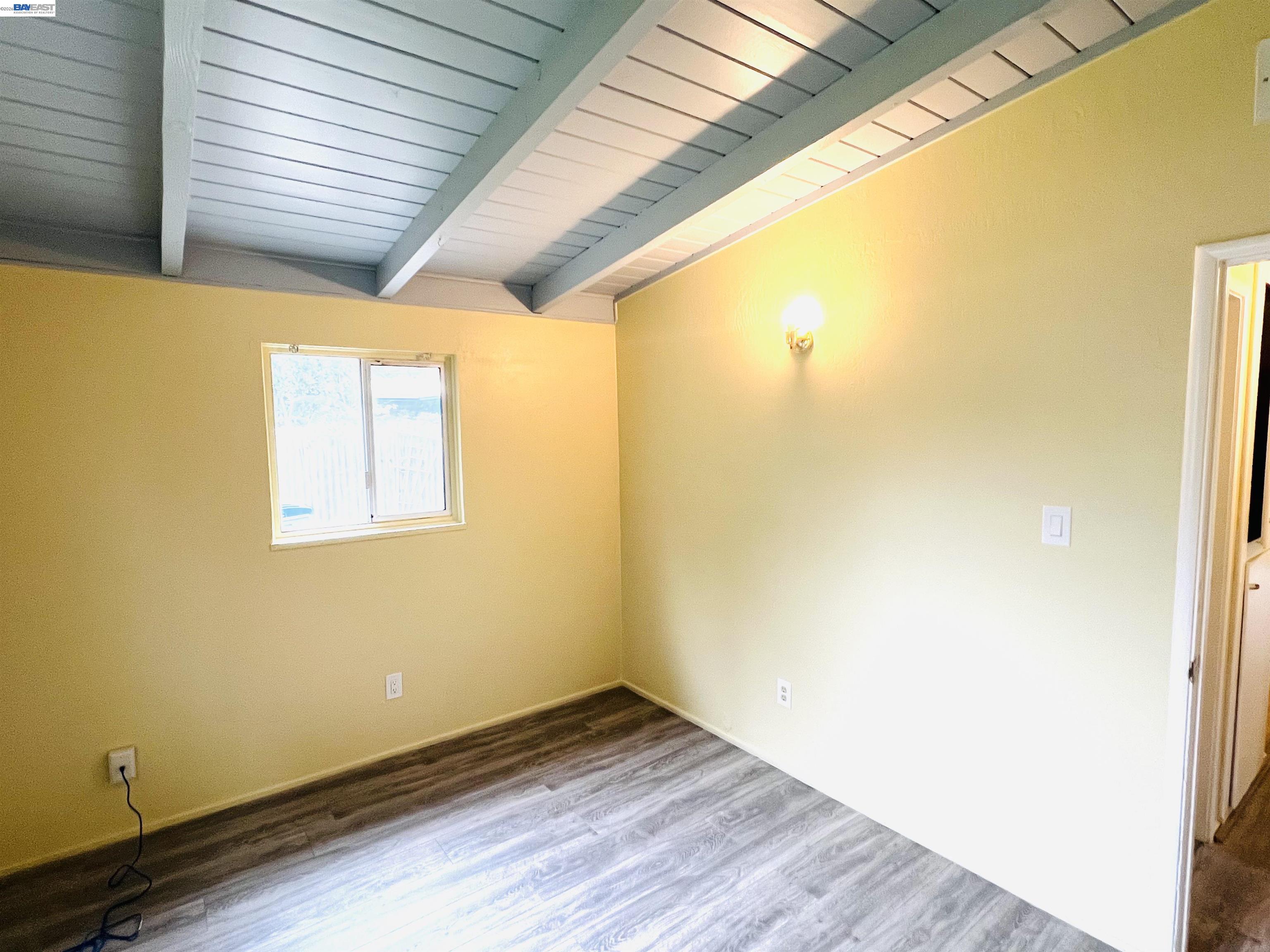 739 M Street Davis, CA 95616 - Photo 10 of 14 a view of an empty room with wooden floor and a window