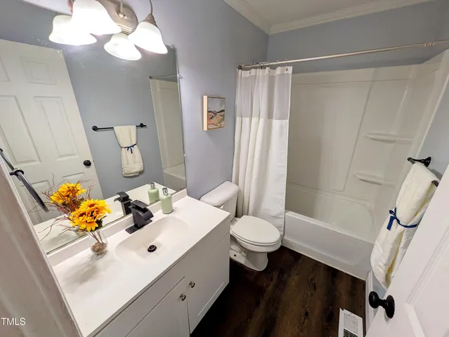 a bathroom with a sink vanity mirror and toilet
