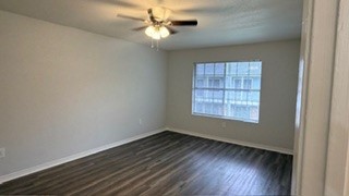 2101 Mustang Road Alvin, TX 77511 - Photo 3 of 9 an empty room with wooden floor chandelier fan and windows