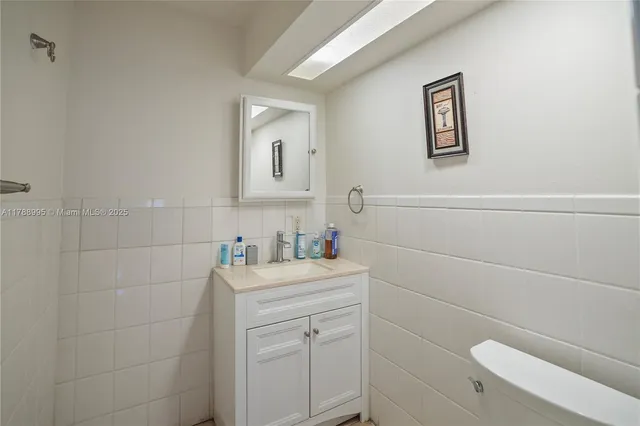 a bathroom with a sink toilet and vanity