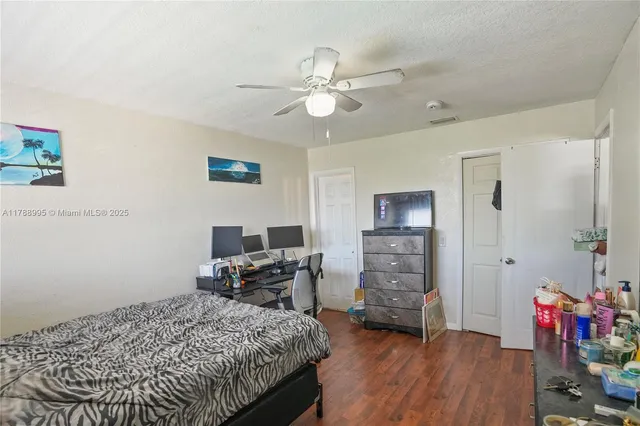 a bedroom that has a bed and a chair in it