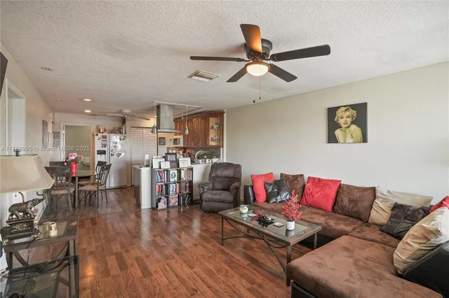a living room with furniture and kitchen view