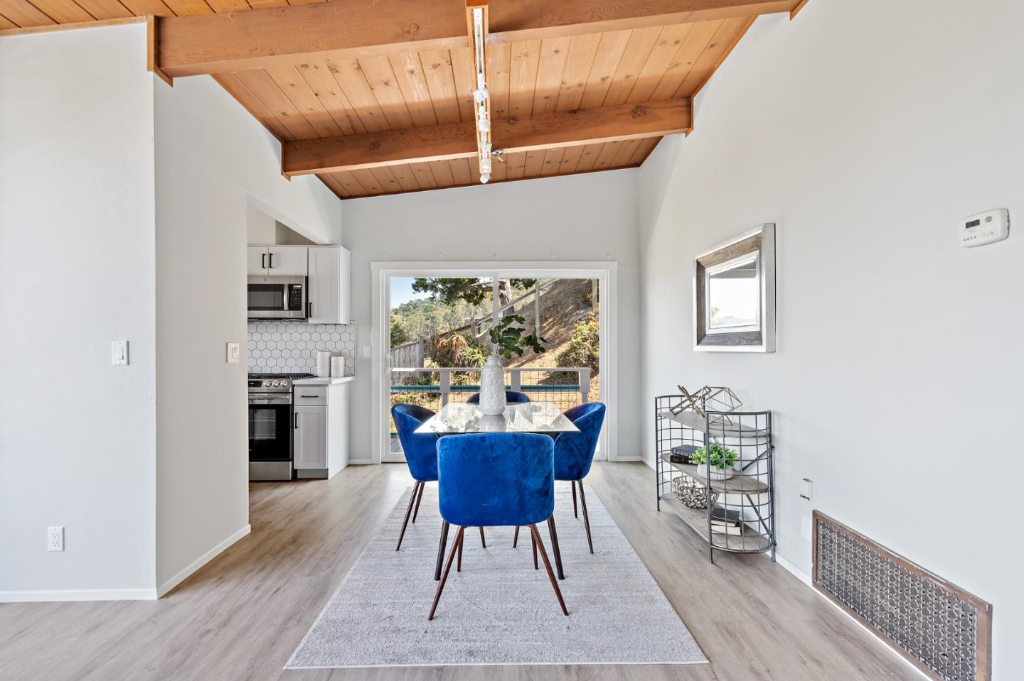 144 Kent Road Pacifica, CA 94044 - Photo 15 of 44 a view of a dining room with furniture window and wooden floor