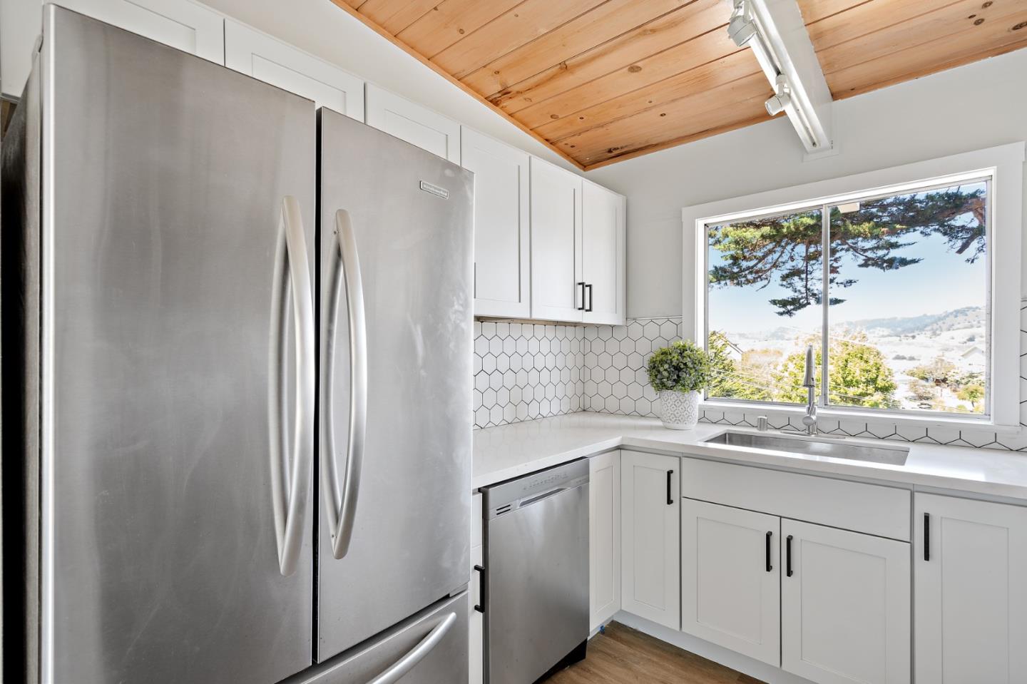 144 Kent Road Pacifica, CA 94044 - Photo 20 of 44 a white refrigerator freezer sitting inside of a kitchen