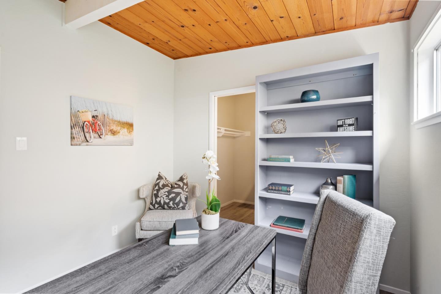 144 Kent Road Pacifica, CA 94044 - Photo 25 of 44 a workspace with furniture and wooden floor
