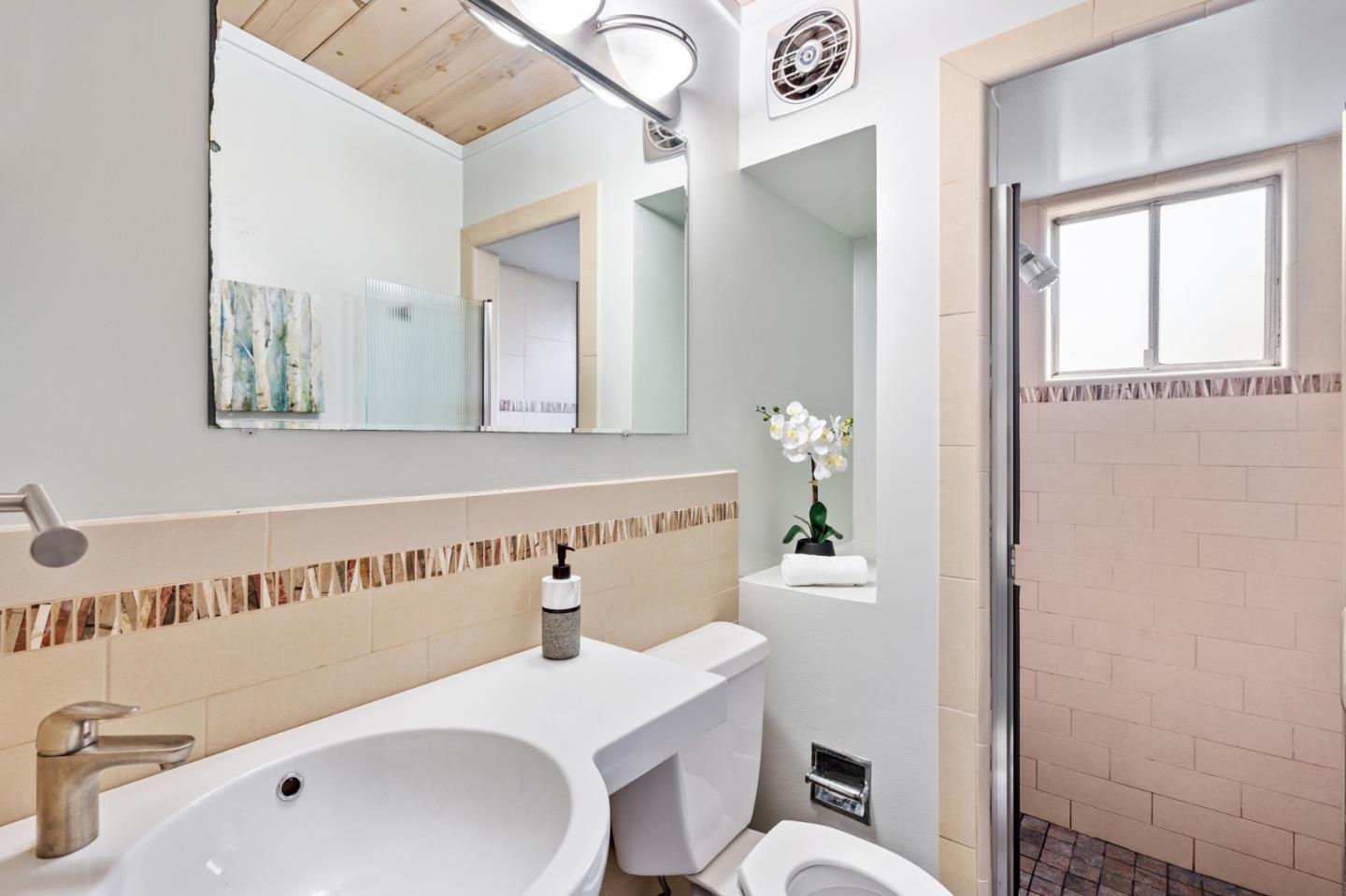 144 Kent Road Pacifica, CA 94044 - Photo 29 of 44 a bathroom with a sink a toilet and mirror