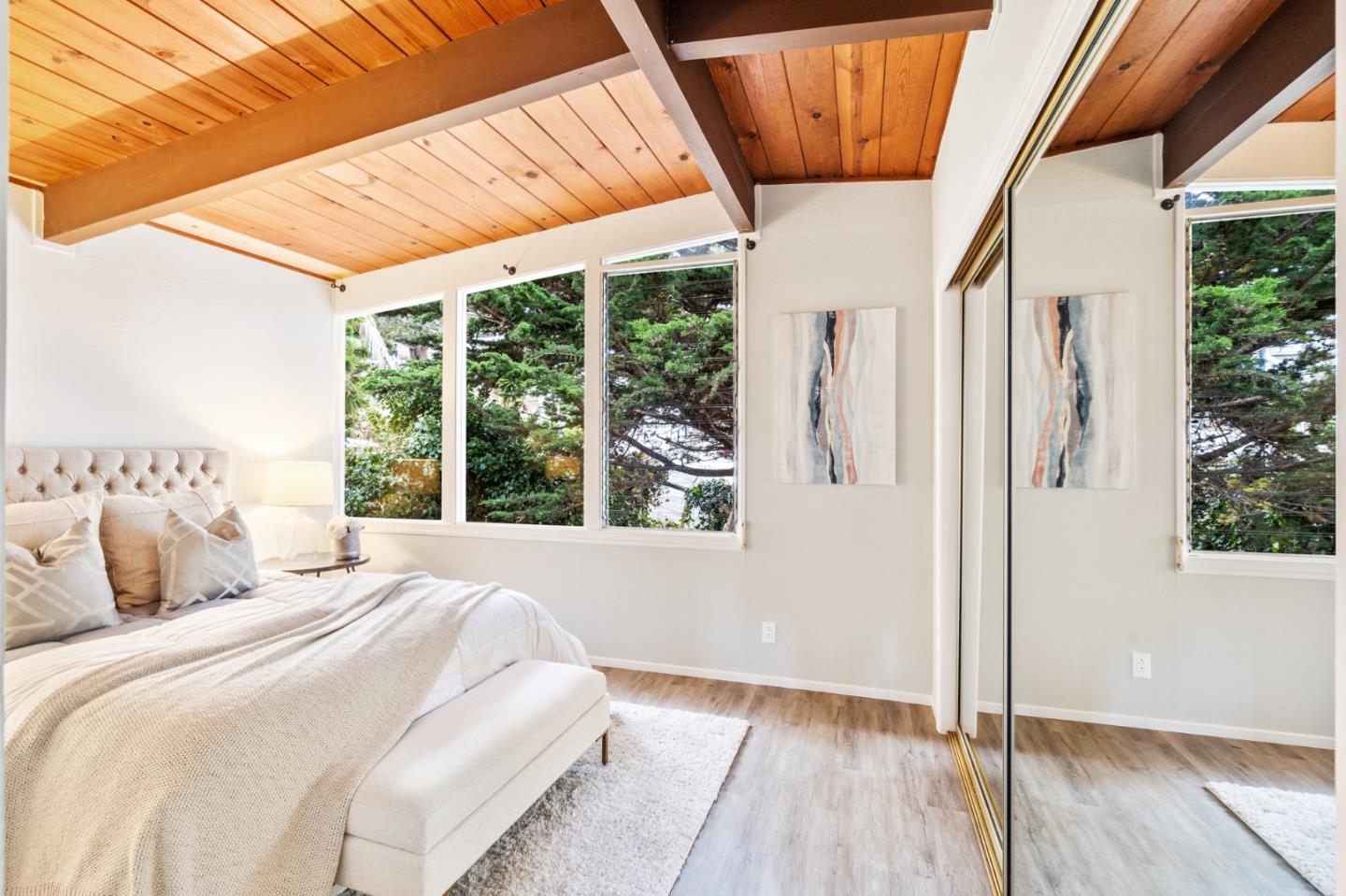 144 Kent Road Pacifica, CA 94044 - Photo 34 of 44 a bedroom with wooden floor and windows
