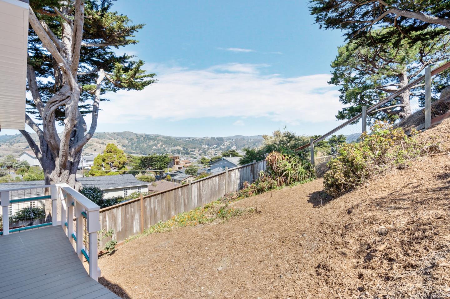 144 Kent Road Pacifica, CA 94044 - Photo 39 of 44 a view of a terrace with a tree
