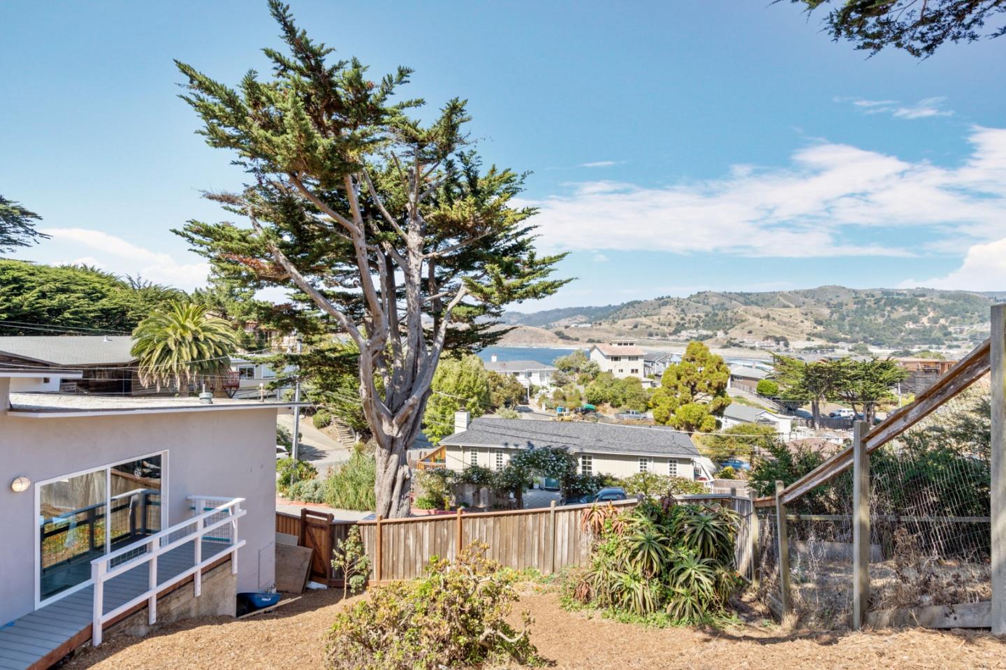 144 Kent Road Pacifica, CA 94044 - Photo 40 of 44 a view of a house with a tree in front of it