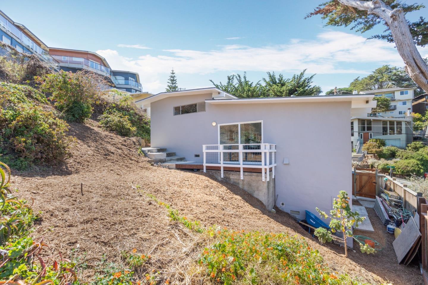 144 Kent Road Pacifica, CA 94044 - Photo 43 of 44 a front view of a house with a yard and garage