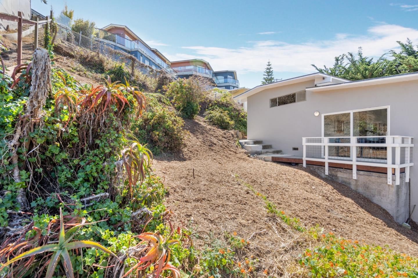 144 Kent Road Pacifica, CA 94044 - Photo 44 of 44 a view of a house with a yard and sitting area