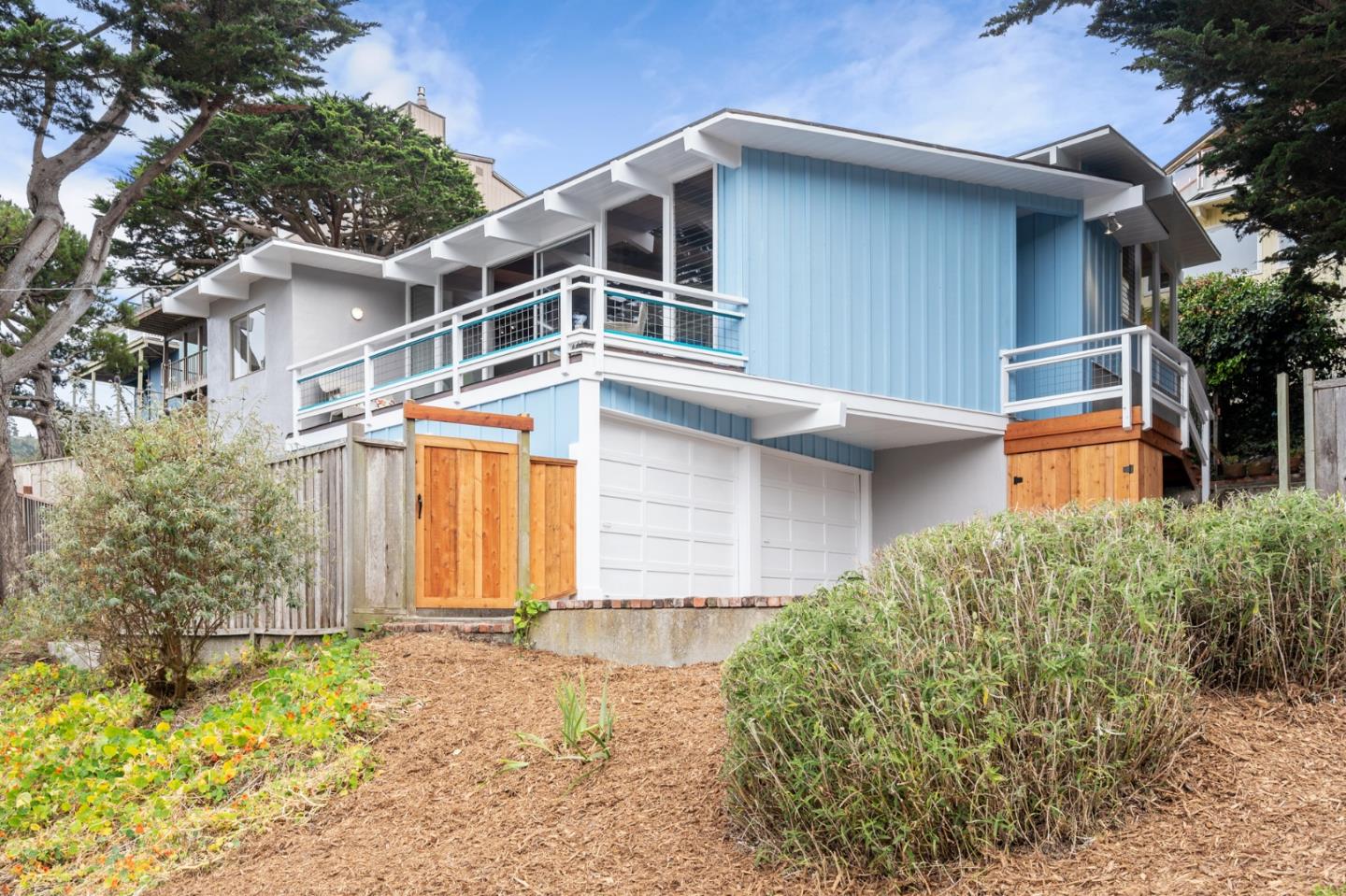 144 Kent Road Pacifica, CA 94044 - Photo 7 of 44 a house with trees in front of it
