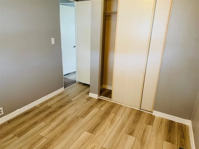 a view of a room with wooden floor and white wall